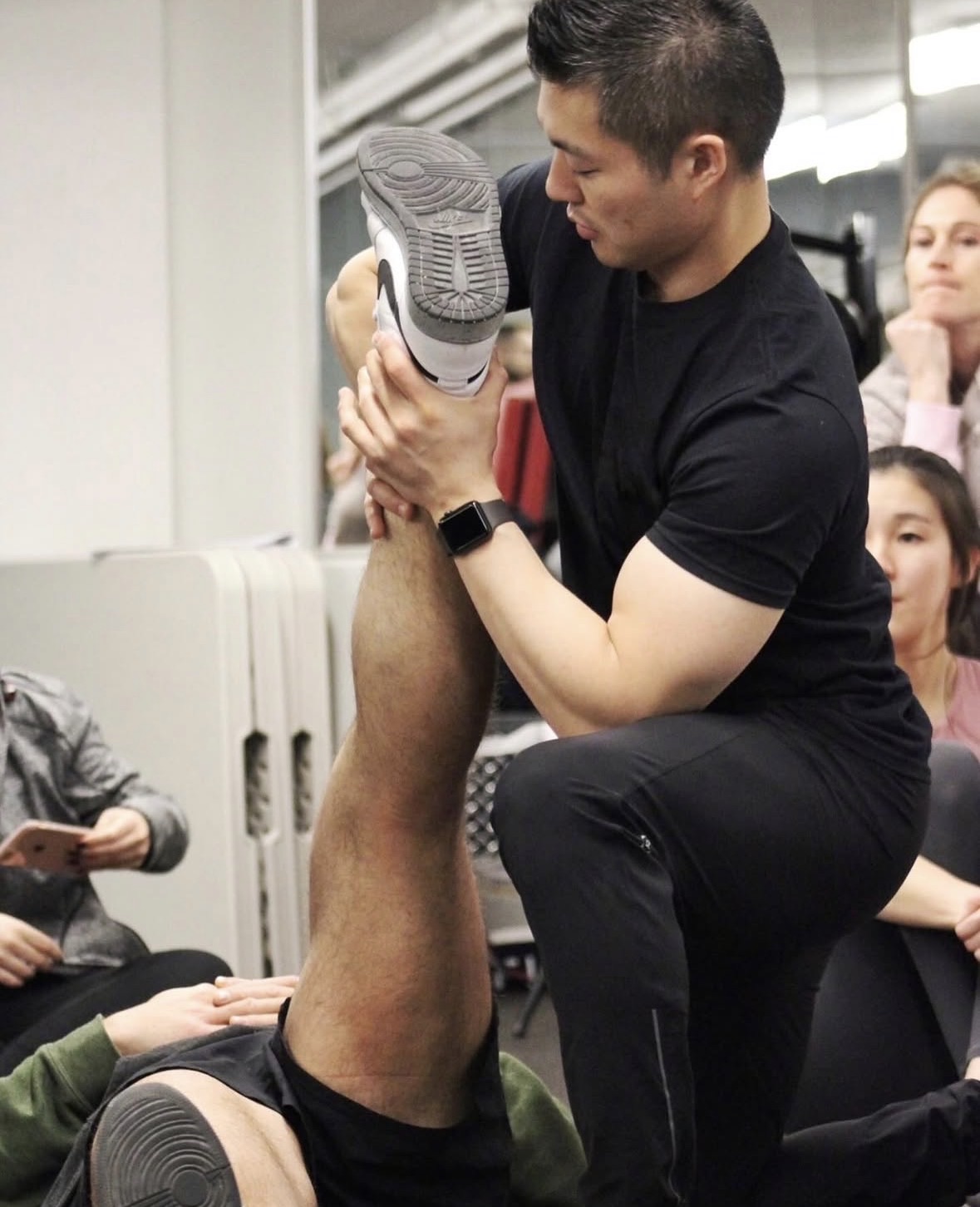 Min Moo (Steve) Lee performing a straight-leg-raise assessment during practitioner education